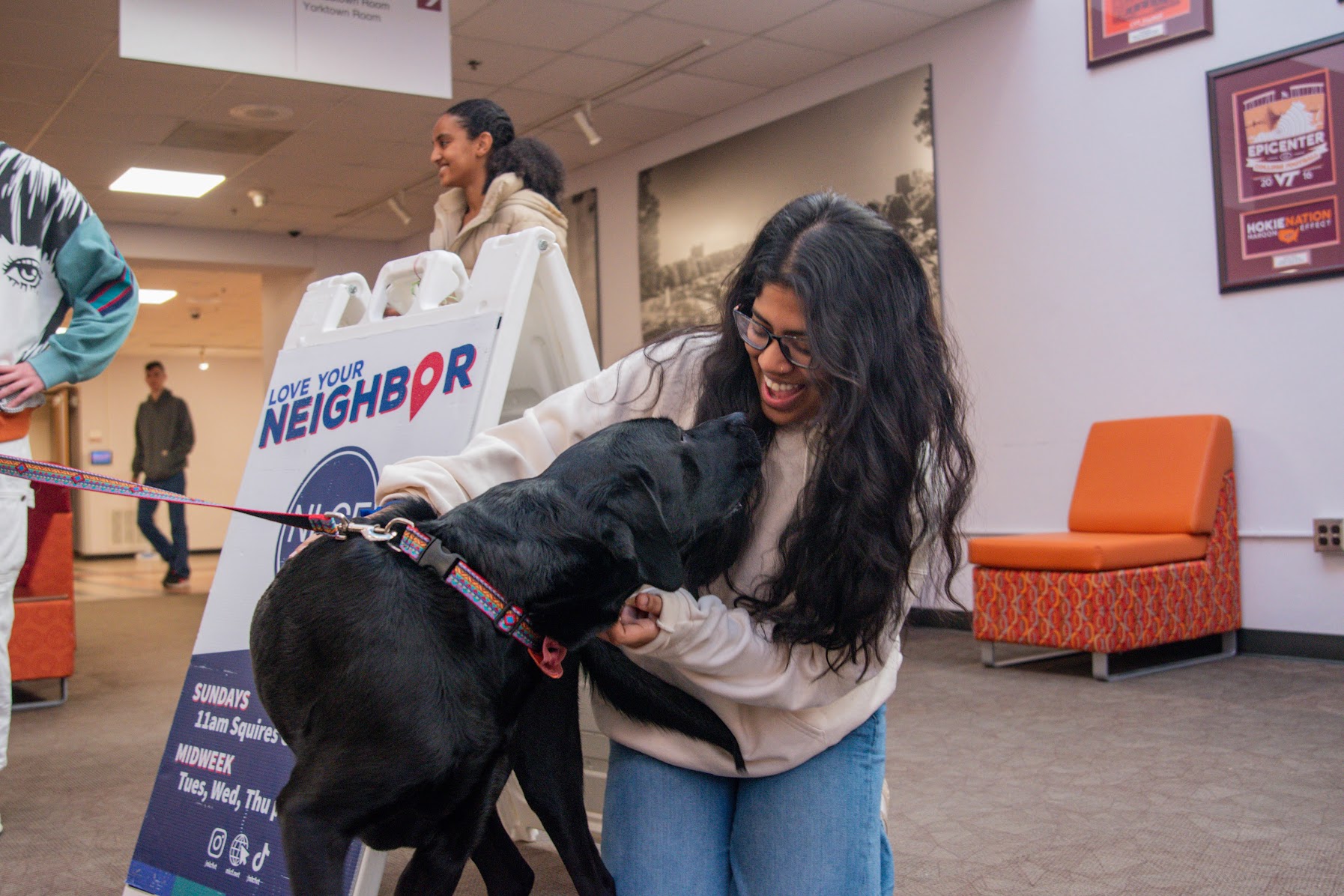 Student petting Virginia Tech therapy dog